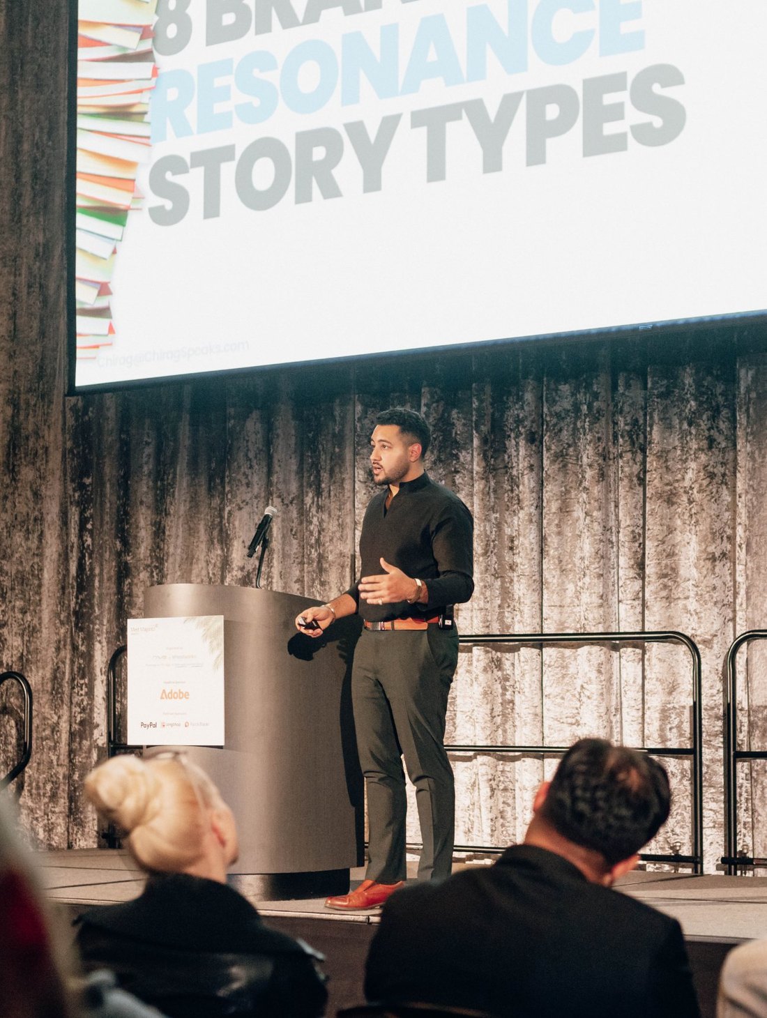 Chirag Speaks on a conference stage in front of a full room